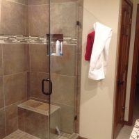 Bathroom Remodeling Contractor design with new shower tiles and seat in a walk in shower