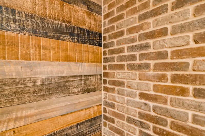 wood and brick walls meet designed by basement remodeling contractor